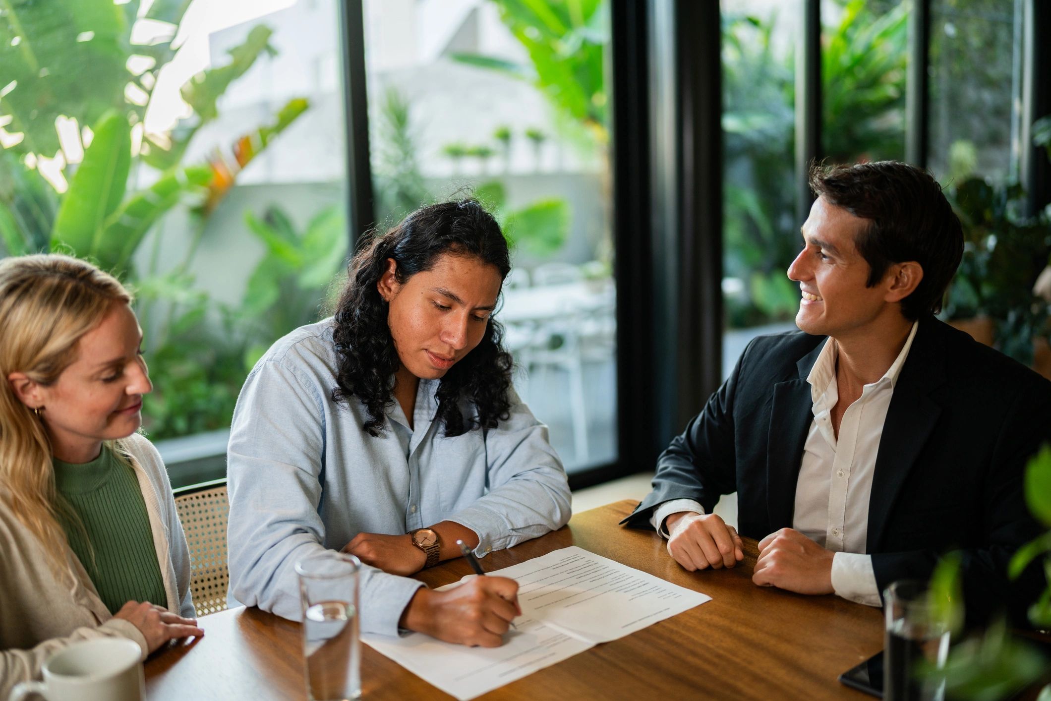 Real estate agent meeting with clients and reviewing documents